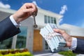 Man Handing a man Thousands of Dollars For Keys in Front of House.