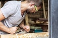 Man handles a wooden with a black jack plane Royalty Free Stock Photo