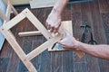Man hands assembling wooden furniture with tools during quarantine isolation Royalty Free Stock Photo