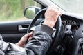 Man hands on car wheel