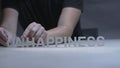 Man hands changing word happiness for unhappiness by letters on gray background