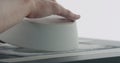 Man hands check bottom of white ceramic bowl