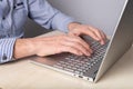 Man hands closeup typing on laptop keyboard. Man sitting at table with computer and working remotely, studying online Royalty Free Stock Photo