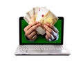 Man hands comming outlaptop holding euro banknotes and ace poker playing cards