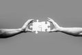 Man hands connecting couple puzzle piece. Business solutions, target, success, goals and strategy concepts. Black and Royalty Free Stock Photo