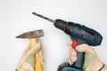Man hands with cordless drill and hammer on white background Royalty Free Stock Photo