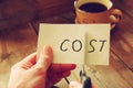 Man hands cutting card with the word cost. business concept, cutting costs Royalty Free Stock Photo