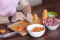 Man hands cutting vegetables for cooking. Carrot and mushrooms, row meat, ingredients for stew or ragout.