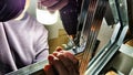 Man hands drilling metal planc in construction. Building iron fence with a drill and screw. Close up of his hand and the Royalty Free Stock Photo