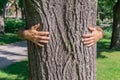 Man hands embracing trunk of tree Royalty Free Stock Photo