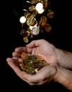 Man Hands full of money receiving a Rain of Coins Royalty Free Stock Photo