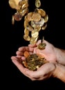 Man Hands full of money receiving a Rain of Coins Royalty Free Stock Photo