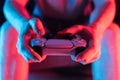 Man hands with game controller in neon light, front view Royalty Free Stock Photo
