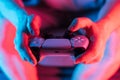 Man hands with game controller in neon light, front view Royalty Free Stock Photo