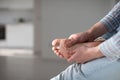 Man hands giving foot massage to yourself to relieve pain after a long walk, due to uncomfortable shoes.Flat feet, leg fatigue Royalty Free Stock Photo