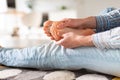 Man hands giving foot massage to yourself to relieve pain after a long walk, due to uncomfortable shoes, suffering from flat feet Royalty Free Stock Photo