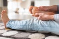 Man hands giving foot massage to yourself to relieve pain after a long walk. Flat feet, leg fatigue Royalty Free Stock Photo