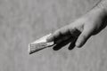 Man hands giving money like a bribe or tips. Holding EURO banknotes on a blurred background, EU currency Royalty Free Stock Photo