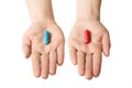 Man hands giving two big pills. Blue and red. Make your selection. Health or ill. Choose your side
