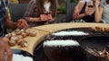 Man hands grilling food for bbq party outside. Guy pouring salt on grill Royalty Free Stock Photo