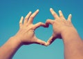 Man Hands in Heart Shape form love on Sky