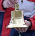Man hands hold vintage ship bell made in 1888 Royalty Free Stock Photo