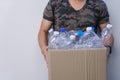 Man hands holding brown recycle paper garbage bin box with recyclable plastic bottle s, garbage for recycling. waste management Royalty Free Stock Photo