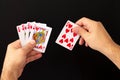 Man hands holding combination of royal flush poker cards on dark background Royalty Free Stock Photo