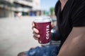Man hands holding cup of Costa coffee in paper cup Royalty Free Stock Photo