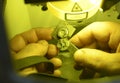 Man hands holding metal pieces in the chamber of the laser device welded by the method of high precision laser