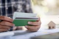 Man hands holding saving account passbook with calculator, account and saving for home loan concept Royalty Free Stock Photo