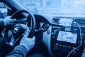 Man hands holding steering wheel. Person sitting in car using smartphone and build-in satellite navigator GPS. Distraction of Royalty Free Stock Photo