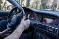 Smolqn, Bulgaria - march 22, 2019 - Man driving Audi, transportation concept, hands holding steering wheel white driving,road