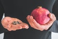 Man hands with iron supplements and pomegranates to treat iron deficiency anemia