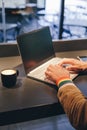 man hands with lgbt bracelet working in laptop