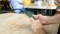 Man hands with mobile phone serf internet and reading news sitting in cafe