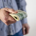 A man hands over a thick wad of dollars