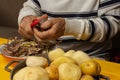 Man hands peeling potato for ajiaco Royalty Free Stock Photo