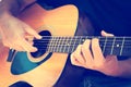 Man hands playing acoustic guitar musical