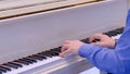 Man hands playing on white grand piano on concert - close up Royalty Free Stock Photo