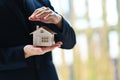 Man hands protecting house model. Property insurance, security and real estate concept Royalty Free Stock Photo