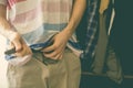 Man hands puts on casual trousers pants or shorts and tight belt close up f