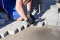 man hands putting pedestrians street stones, pavement bricks. Bricklayer work on sidewalk and lays out paving slabs Royalty Free Stock Photo