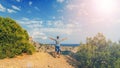 Man with hands raised outdoors in summer on the background of the sea on the top of the mountains Royalty Free Stock Photo