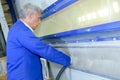 Man with hands in sandblasting machine