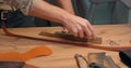 man hands sharpening Leather Edge Beveler before cutting the edge of belt