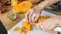 Man hands slicing pumpkin on cubes on cutting board Royalty Free Stock Photo