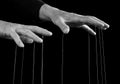 Man hands with strings on fingers. Dominator, abuser using power to make person feel humiliated. Manipulation, negative Royalty Free Stock Photo