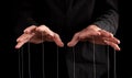 Man hands with strings at fingers. Manipulator controlling, exploiting person, showing power in relationship, at work