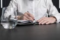 Man hands taking notes in planner. Employee sitting at desk and writing plans. Business planning concept. Royalty Free Stock Photo